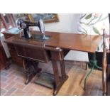 A treadle Singer sewing machine in oak case