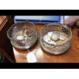 A pair of silver plated wine coasters on rollers t