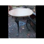 A circular cast iron and wooden pub table