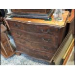 An antique mahogany serpentine fronted chest of fo
