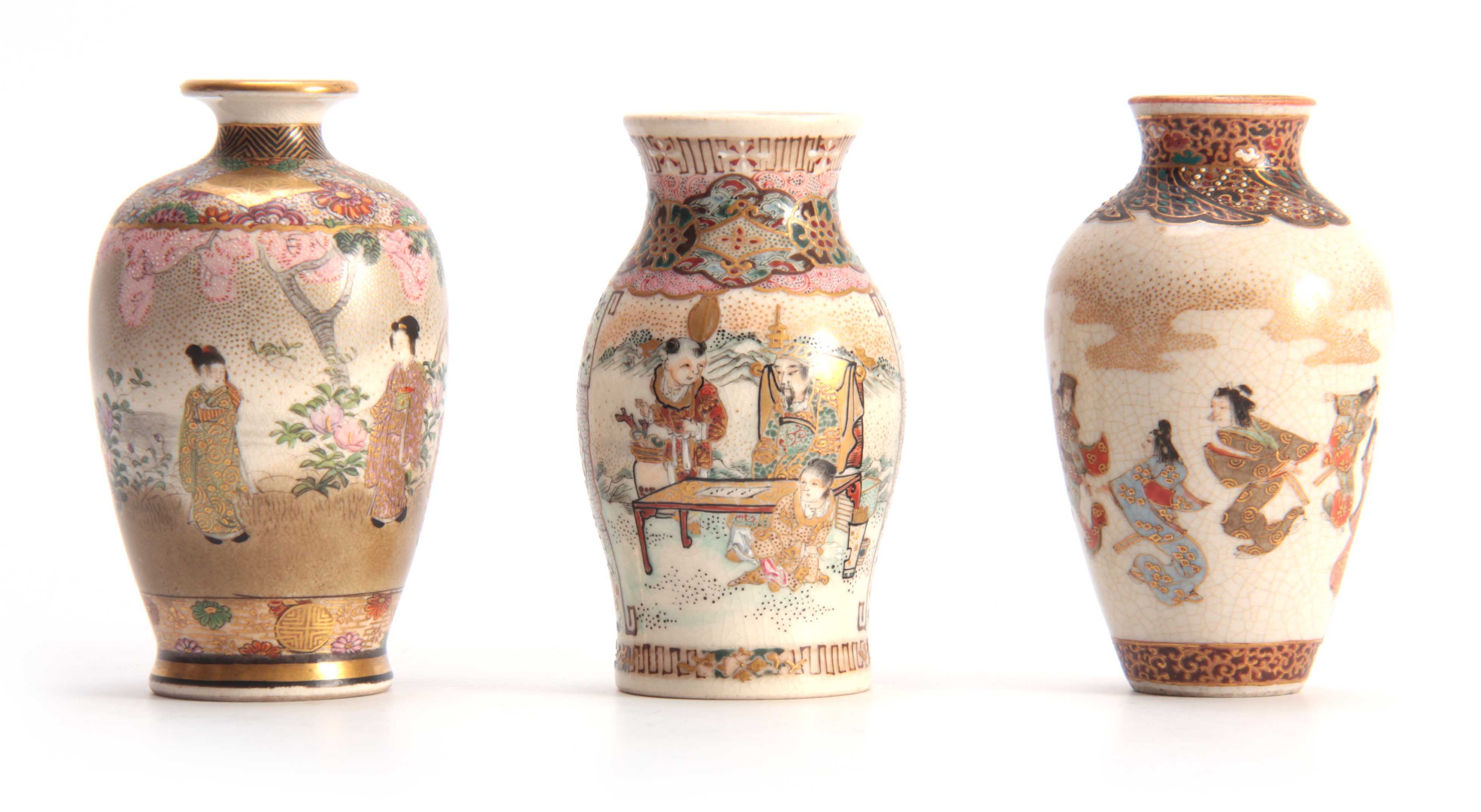 A GROUP OF THREE SMALL SATSUMA CABINET VASES with figures in a continuous landscape scene enclosed