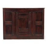 A 17TH CENTURY OAK WELSH HANGING FOOD CUPBOARD constructed of joined panels with central hinged door