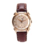 A 1950's GENTLEMANS BENRUS DAY/DATE WRIST WATCH the gold plated case with ornate lugs enclosing a