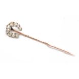 A YELLOW GOLD AND DIAMOND SET HORSESHOE STICK PIN in fitted case