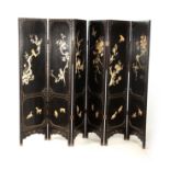 AN EARLY 20TH CENTURY CHINESE SIX SECTIONAL HINGED PANELLED EBONISED AND MOTHER OF PEARL SCREEN