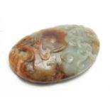 A CHINESE RUSTIC JADE CARVED PAPERWEIGHT having raised scrollwork decoration with a knobled textured