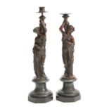 A PAIR OF LATE 19TH CENTURY FRENCH BRONZE FIGURAL CANDELABRA DEPICTING CLASSICAL WATER CARRIERS