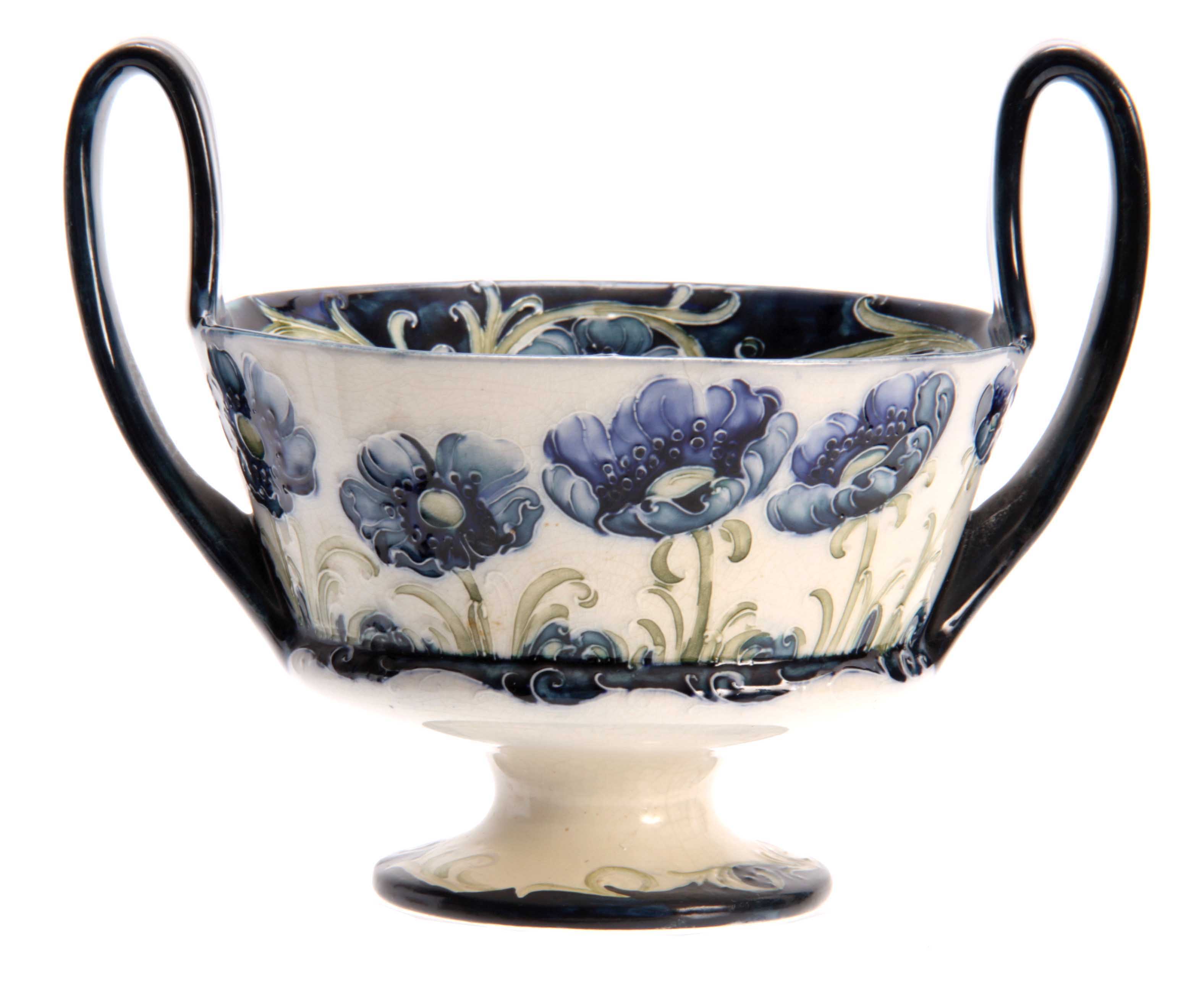 A MACINTYRE, BURSLEM WILLIAM MOORCROFT RAISED TWO-HANDLE FOOTED BOWL with tube lined blue Poppy