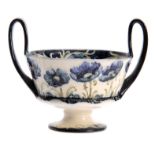 A MACINTYRE, BURSLEM WILLIAM MOORCROFT RAISED TWO-HANDLE FOOTED BOWL with tube lined blue Poppy