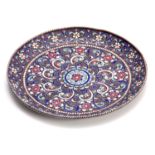 A RUSSIAN SILVER AND COLOURED ENAMEL SMALL SHALLOW DISH with beaded flowerhead and scrolled leaf