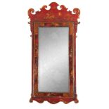 A GEORGE III RED LACQUER CHINOISERIE HANGING WALL MIRROR with shaped fret cut corners surrounding