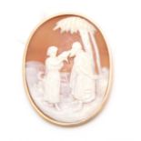 A 9CT YELLOW GOLD MOUNTED OVAL CAMEO BROOCH depicting figures in a Middle Eastern setting 5cm
