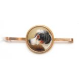 A 9CT YELLOW GOLD TIE PIN set with a circular porcelain disc painted with a head of a Hound - signed
