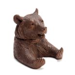A 19TH CENTURY SWISS CARVED BLACK FOREST BEARS HEAD INKWELL with hinged lid and arms outstretched