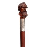 AN EARLY 20th CENTURY CARVED CHARLES DICKENS WALKING CANE the realistically carved handle on a large