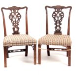 A PAIR OF GEORGE III CHIPPENDALE STYLE SIDE CHAIRS with elaborate pierced leaf carved backs,
