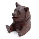 A 19TH CENTURY SWISS CARVED BLACK FOREST BEARS HEAD INKWELL with hinged lid and arms outstretched