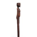 AN AFRICAN CARVED HARDWOOD WALKING CANE the handle modeled as a standing figure 91cm overall