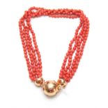 AN 18CT YELLOW GOLD AND MULTI STRING CORAL BEAD NECKLACE with diamond star-spangled ball fastener