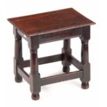 A LATE 17TH CENTURY OAK JOINT STOOL with plank top above ring turned legs joined by under stretchers