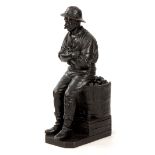 E E GEFLAWSKI A LATE 19TH CENTURY LARGE BRONZE SCULPTURE depicting a Miner seated on a coal tub,