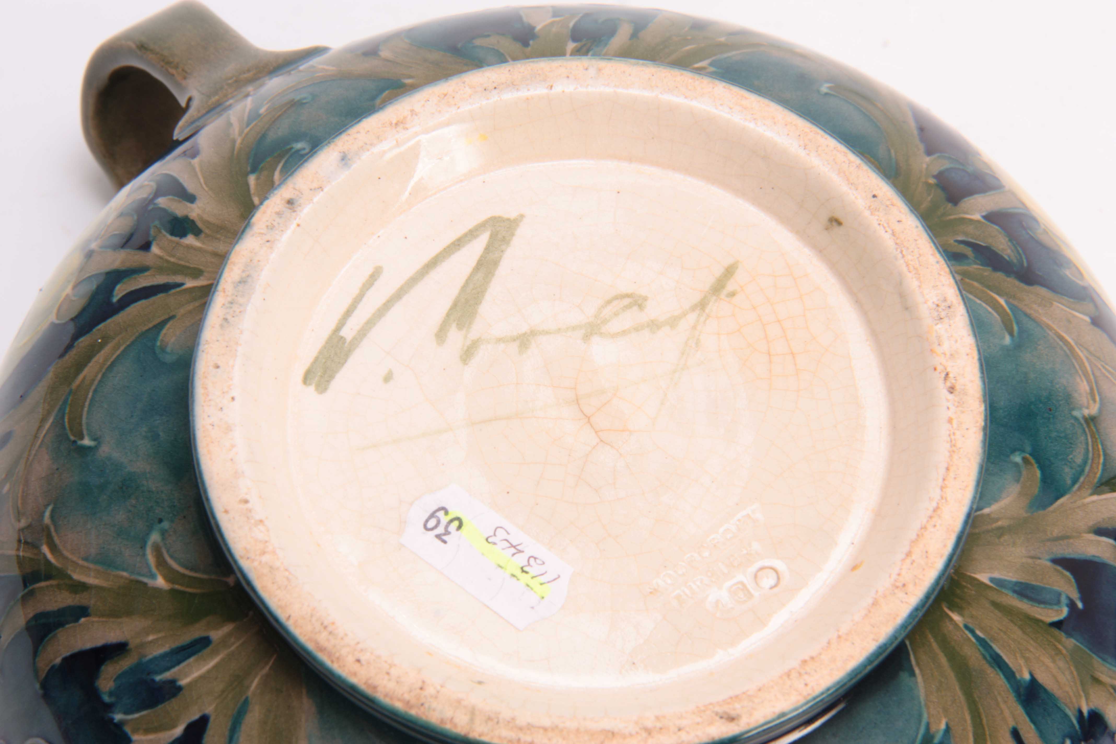 A WILLIAM MOORCROFT BURSLEM FOOTED TWO-HANDLED BOWL with flowerhead and leaf spray decoration on a - Image 3 of 3