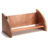 A ROBERT MOUSEMAN THOMPSON OAK BOOK TROUGH of adzed form with curved ends and carved mouse trademark