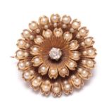A 15CT GOLD PEARL AND DIAMOND SET FLOWERHEAD BROOCH - tested 15ct gold 2.5cm diameter.
