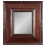 AN UNUSUAL WILLIAM AND MARY CHAMFERED EDGE WALNUT HANGING MIRROR with cushion-shaped inner frame