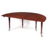 A GEORGE III FIGURED MAHOGANY CURVED HUNT TABLE with a removable top section, drop-down rear leaves;