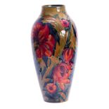 A WILLIAM MOORCROFT BURSLEM SPANISH PATTERN SLENDER TAPERING SHOULDERED VASE with all over tube