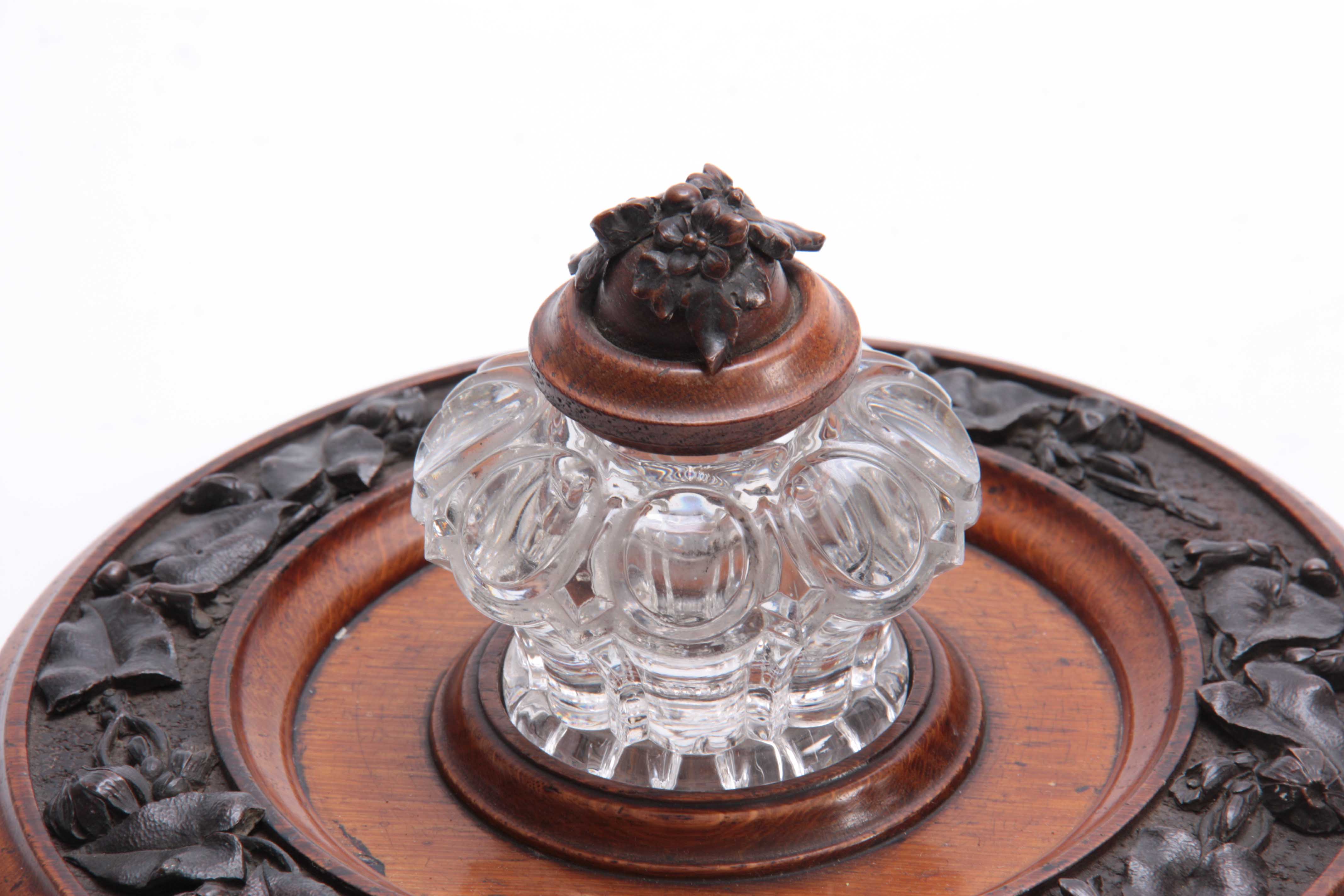A 19TH CENTURY CARVED OAK CIRCULAR INK STAND with cut glass inkwell to the centre having a floral - Image 2 of 5