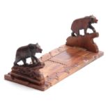 A LATE 19TH CENTURY SWISS BLACK FOREST CARVED ADJUSTABLE BOOKREST with bears to each side on