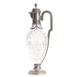 A FABERGE TALL CUT GLASS CLARET JUG the oval elongated body with star-cut panels on a circular