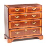 AN EARLY 18TH CENTURY QUEEN ANNE WALNUT AND ASH CROSS-BANDED CHEST OF DRAWERS OF SMALL SIZE having a