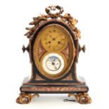 A LATE 19th CENTURY FRENCH ORMOLU MOUNTED BLACK AND ROUGE MARBLE CALENDAR CLOCK surmounted by an