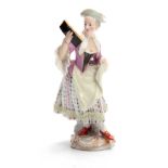 A 19TH CENTURY MEISSEN STATUE OF A YOUNG LADY reading a book decorated in brightly painted dress -