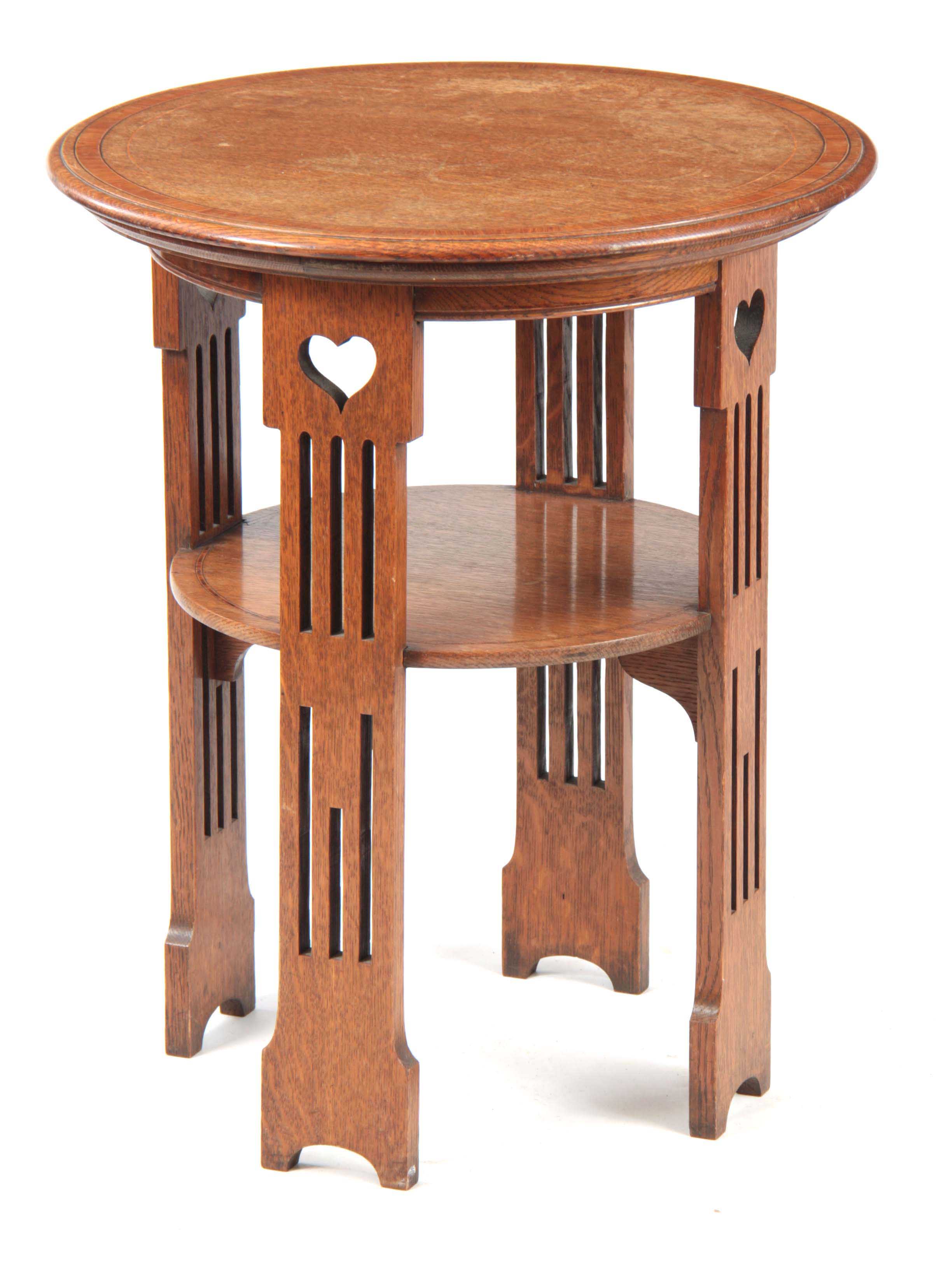 A LIBERTY STYLE ARTS AND CRAFTS OAK OCCASIONAL TABLE having a circular top with kingwood