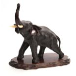 A JAPANESE MEIJI PERIOD PATINATED BRONZE SCULPTURE modelled as an elephant with ivory tusks