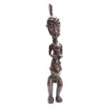 A LATE 19th/EARLY 20th CENTURY CARVED AFRICAN TRIBAL FIGURE modelled as a standing naked man 70cm