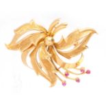 AN 18CT GOLD AND RUBY SET BROOCH designed as leaves and berries - hallmarked 18ct 52mm wide.