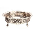 A LATE 19th CENTURY SILVER EMBOSSED SUGAR BOWL with a beaded rim and foliate decoration on three