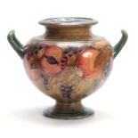 AN EARLY WILLIAM MOORCROFT LARGE TWO-HANDLED FOOTED BULBOUS VASE tube lined and decorated with a