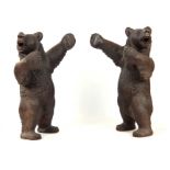AN INTERESTING PAIR OF LATE 19TH CENTURY SWISS CARVED BLACK FOREST STANDING BEARS with glass eyes