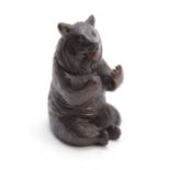 A 19TH CENTURY SWISS CARVED BLACK FOREST SEATED BEAR INKWELL with hinged lid and arms outstretched