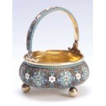 A RUSSIAN SILVER GILT CAULDRON SHAPED BASKET WITH FOLDING HANDLE AND BALL FEET finely decorated in