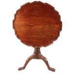 A MID 18TH CENTURY SCOTTISH FIGURED MAHOGANY TILT TOP TABLE with one-piece moulded pie crust top,