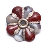 A SCOTTISH ENGRAVED SILVER MOUNTED TWO-COLOUR HARDSTONE BROOCH of flower head form with alternate