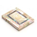 A 19TH CENTURY TWO-TONE MOTHER OF PEARL ENGRAVED CARD CASE with flower head carved relief panel to