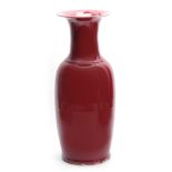 A LARGE 19TH CENTURY CHINESE OXBLOOD PORCELAIN VASE with flared neck and bulbous body 55cm high.